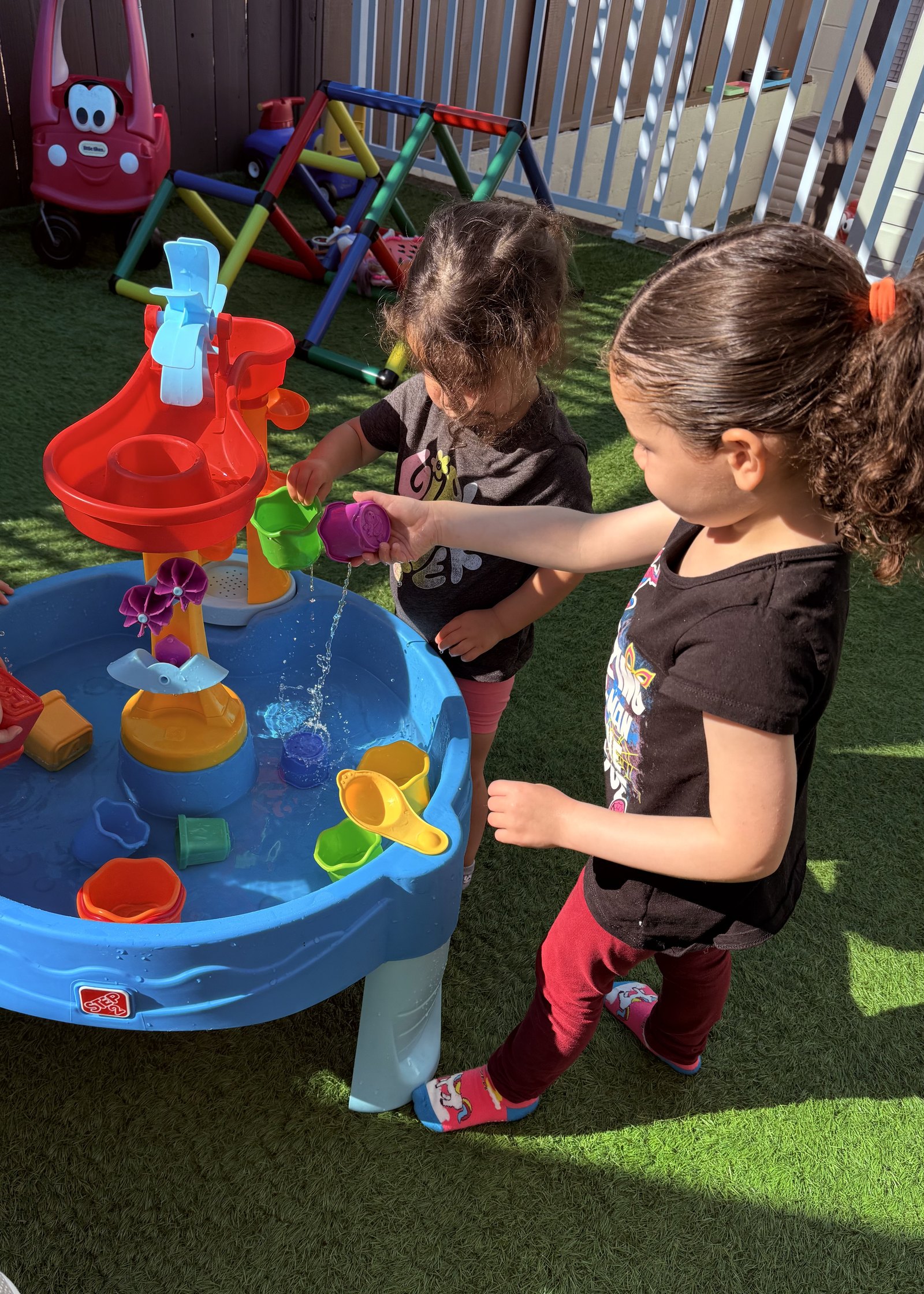 Children exploring water play outdoors
